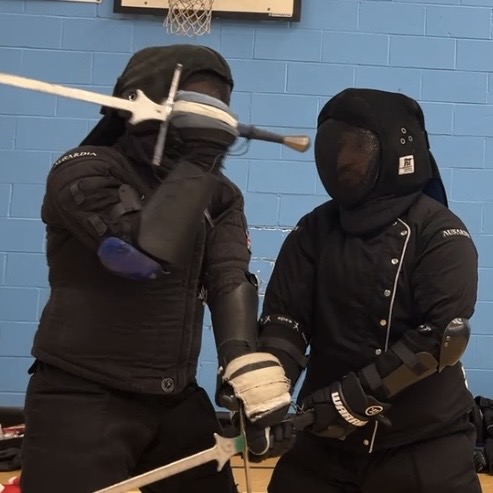 Olgun Tiltay learning Longsword manipulation from Cosmas Cieplak-Mayr von Baldegg HEMA instructor in Ausardia